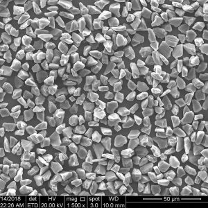 HDY micron powder at 1500x, blocky monocrystalline crystals with sharp edges, 50 micron scale bar