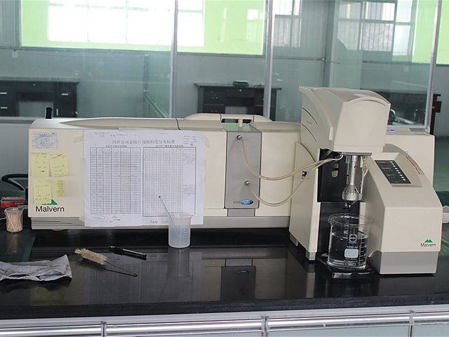 Quality control technician operating a microscope